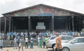  ?? /AFP ?? Pupils are gathered in front of Saint-Michel church as they rally to protest against a change in the rules for university study grants, on Tuesday in Libreville.