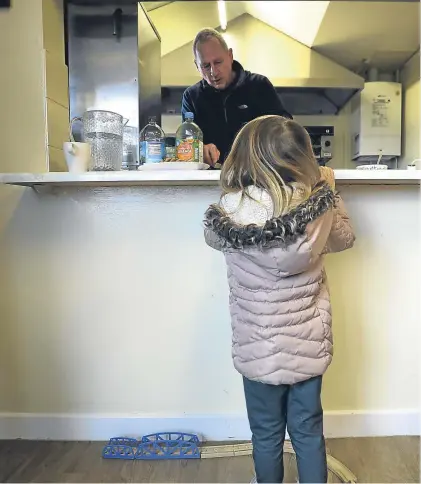  ?? Kris Miller. ?? A young child gets a snack from the kitchen at the Arbroath Town Mission drop-in cafe.