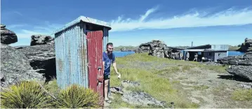  ??  ?? Privy to greatness . . . Visiting from Invercargi­ll, Josh Haywood emerges from the “Grahame Sydney” toilet at the Heyward Hut at a part of the Poolburn Dam known locally as Drunken Woman’s Arm. The arm is actually a gully that was flooded when the Poolburn Dam was built in the 1930s. It got its name because there was an old stone hotel in the gully run by a woman called ‘‘Hobart Town Annie’’.