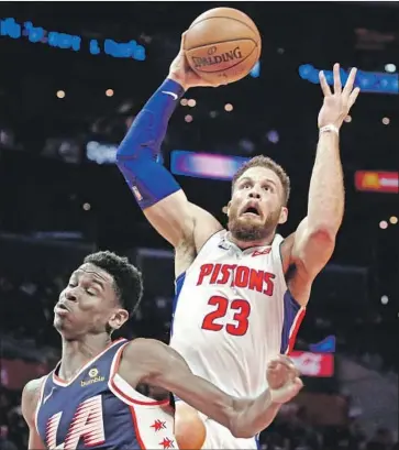  ?? Ringo H.W. Chiu Associated Press ?? BLAKE GRIFFIN of the Detroit Pistons goes to the basket during the first half behind Shai GilgeousAl­exander of the Clippers. Griffin scored 26 points in the half on the way to 44 points.