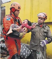  ?? ?? Brazilian rescuers carry a girl found after 12 hours under the rubble of her house, Petropolis, Brazil, March 23, 2024.