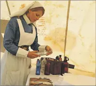  ?? CHRIS SHANNON/CAPE BRETON POST ?? Exhibit animator Kelci Martinsen played the role of a nursing sister at the travelling First World War Comes to Life exhibit currently on tour in Atlantic Canada. The medical tent is one of the more popular displays, with Martinsen explaining to...