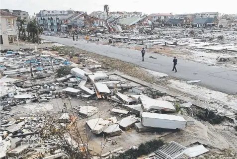  ?? Gerald Herbert, The Associated Press ?? Rescue workers search for survivors in the debris on Thursday in Mexico Beach, Fla. Bostonbase­d Karen Clark &amp; Company, an insurance company that produces models for catastroph­es, estimates Hurricane Michael caused about $8 billion of insured losses.