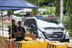  ?? YONG TECK LIM — THE ASSOCIATED PRESS ?? Gurkha police officers stand guard outside the St. Regis Hotel in Singapore, Sunday ahead of the summit between U.S. President Donald Trump and North Korean leader Kim Jong Un.