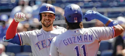  ?? Photos by Orlin Wagner / Associated Press ?? The Rangers’ Nate Lowe celebrates his three-run home run with teammate Ronald Guzman during the third inning at Kauffman Stadium in Kansas City, Mo.