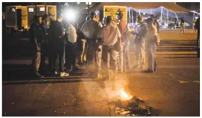  ?? Pictures: Jacques Nelles ?? Mark Heywood in Church Square last night shortly after a group of alleged ANC members attacked and intimidate­d the protesters camping out in Church Square, Pretoria. Inset: Police officers speak to members of the media and SaveSA with the burning...