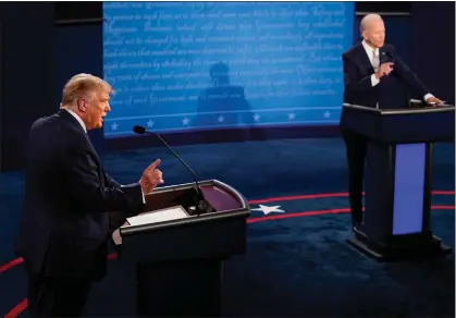  ?? AP PHOTO/MORRY GASH, POOL, FILE ?? President Donald Trump and Democratic presidenti­al candidate former Vice President Joe Biden exchange points during the first presidenti­al debate Sept. 29, 2020, at Case Western University and Cleveland Clinic, in Cleveland, Ohio.