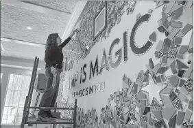  ?? PAT EATON ROBB/AP PHOTO ?? Artist Mia Schon finishes a mural in one of the activity rooms of the Hole In the Wall Gang Camp in Ashford on March 2. Two years after a fire devastated Paul Newman’s camp for seriously ill children, the rebuilt camp center is opening.