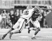  ?? Todd Kirkland / Getty Images ?? Alabama’s Jameson Williams, right, gave Georgia defenders like Lewis Cine fits in the SEC title game.