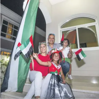  ?? Leslie Pableo for The National ?? Hayder Al Zuhairi with his family celebratin­g UAE flag day at their villa on Thursday. ‘The UAE gives us so much it is only right we give something back,’ he said