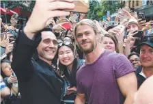  ??  ?? Tom Hiddleston and Chris Hemsworth in Brisbane CBD.