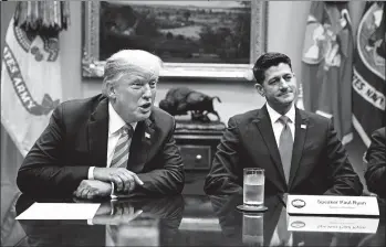  ?? EVAN VUCCI/AP ?? House Speaker Paul Ryan, R-Wis., showed the president glossy photos of a wall being built along the U.S.-Mexico border.