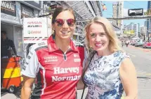  ?? Picture: GLENN HAMPSON ?? Supercar driver Simona De Silvestro with Games Minister Kate Jones before the race start.