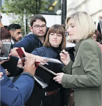  ?? MICHAEL WRIGHT/WENN ?? Jodie Whittaker is swamped by Doctor Who fans on the streets of London.