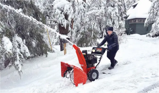  ?? Associated Press ?? ↑
Betty Tidd, 78, clears snow in Gilford, New Hampshire, on Friday.
