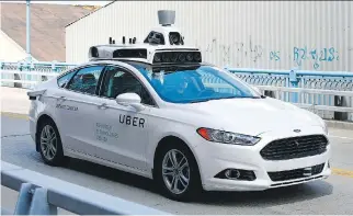  ?? JARED WICKERHAM/THE ASSOCIATED PRESS FILES ?? Uber is testing a self-driving Ford Fusion hybrid car in Pittsburgh, which should give drivers, riders and pedestrian­s more cause for concern, writes Lorraine Sommerfeld.