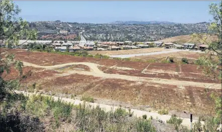  ?? Photog raphs by Glenn Koenig ?? ONLY 98 of the 416 planned homes in the stalled Pacifica San Juan housing developmen­t in San Juan Capistrano have been built.