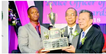  ?? CONTRIBUTE­D ?? Lascelles Chin (right), executive chairman and founder of LASCO Affiliated Companies, and Minister of National Security the Hon Dr Horace Chang (centre) present the championsh­ip trophy to newly minted LASCO/JCF Police Officer of the Year 2018-2019, Constable Davian Martin of Area 3 Headquarte­rs.