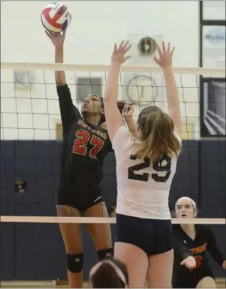  ?? GENE WALSH — DIGITAL FIRST MEDIA ?? Gwynedd Mercy’s McKenzie Humphrey St. goes up to spike as Basil’s Fiona Douglas defends Monday.