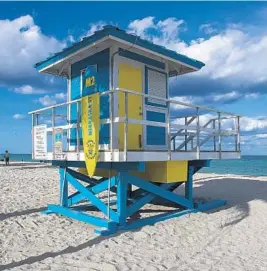  ?? MICHAEL LAUGHLIN/SUN SENTINEL ?? Hollywood officials say the new lifeguard tower stands made of marine-grade plywood and stainless steel are expensive to build. The city has already spent more than $2 million on 21 new stands.