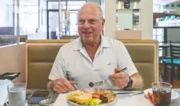  ??  ?? “It’s a classic deli,” says regular customer Hershey Roitman enjoying a “lunch of champions” featuring carp. The devoted Roitman eats here once and sometimes twice a day.