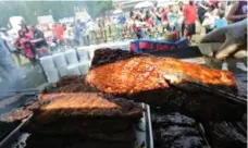  ?? VINCE TALOTTA/TORONTO STAR FILE PHOTO ?? Barbecue masters baste their rack of ribs at Toronto’s RibFest in 2013.