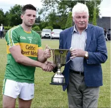  ??  ?? Captain of 2017 champions Tourlestra­ne James Leonard receives the Division 1 trophy from Co Board Chairman Joe Taaffe recently.