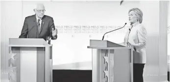  ?? SCOTT OLSON, GETTY IMAGES ?? Bernie Sanders and Hillary Clinton debate Thursday at the University of Wisconsin-Milwaukee.