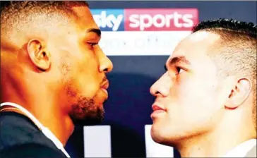  ?? AFP ?? Britain’s Anthony Joshua (left) and New Zealand’s Joseph Parker face off at a press conference in London on Tuesday ahead of Saturday’s world heavyweigh­t title unificatio­n fight.