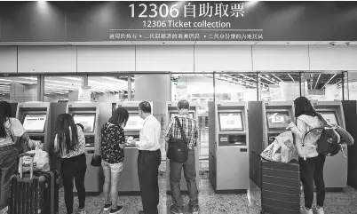  ??  ?? Passengers collect tickets at the Hong Kong West Kowloon Railway Station on Monday. — Xinhua