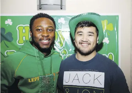  ??  ?? Marc Tehoumy, left, and Gabe Ordonia don the green for the rugby club’s St. Patrick’s Day bash.