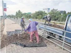  ??  ?? ROAD TO DEVELOPMEN­T: A constructi­on site in Vientiane. Laos is stepping up its infrastruc­ture drive to stimulate growth.