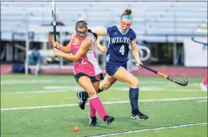  ?? Gretchen McMahon / For Hearst Connecticu­t Media ?? Wilton's Charlotte Casiraghi (4) pursues a Ridgefield player during Wednesday's game.