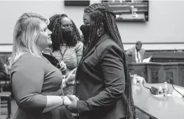  ?? Jacquelyn Martin / Associated Press ?? Rep. Cori Bush, D-Mo., right, who testified about her experience being raped and her choice to have an abortion, holds hands with Rep. Kat Cammack, R-Fla.