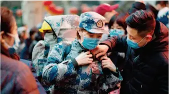  ??  ?? January 24, 2020: Members of the medical team of the Air Force Medical University say goodbye to their families before rushing to Wuhan to aid the fight against the novel coronaviru­s outbreak. by Zhang Haopeng/xinhua