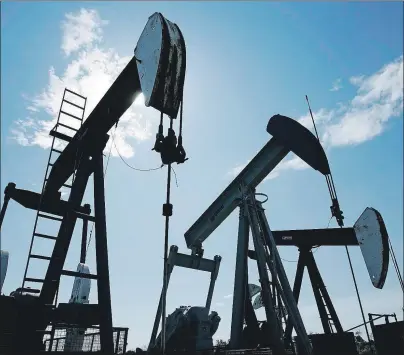  ?? CP PHOTO ?? Pumpjacks are shown pumping crude oil near Halkirk, Alta., June 20, 2007. Canadian drillers and other oilfield service providers have stepped up merger and acquisitio­n activity, with more deals expected in coming months, as players battered by more...