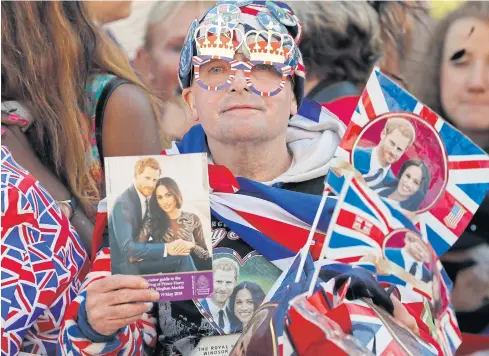  ??  ?? ROYAL FAN: A man decked out in the Union Jack waits for the wedding ceremony of Prince Harry and Meghan Markle at St George’s Chapel in Windsor.