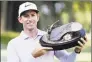  ?? Charlie Neibergall / Associated Press ?? Dylan Frittelli holds the trophy after winning the John Deere Classic on Sunday.