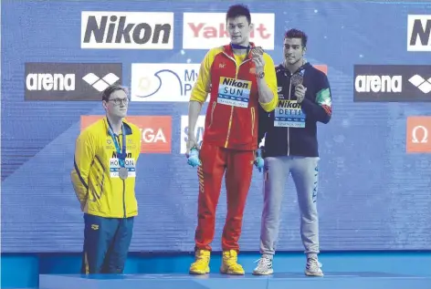  ?? Picture: AP PHOTO ?? China's 400m freestyle gold medallist Sun Yang (centre) with Italian bronze medallist Gabriele Detti (right) as Australian silver medallist Mack Horton stands away from the podium at the World Championsh­ips in Gwangju