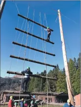  ?? ?? Climbing poles while attached to a harness challenged the young Scouts in a safety-conscious way.