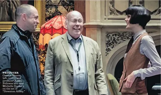  ?? Jaap Buitendijk Focus Features ?? PRODUCER
Gareth Neame, left, writer and producer Julian Fellowes and star Michelle Dockery on the set of “Downton Abbey.”