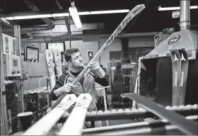  ?? BLOOMBERG ?? An employee inspects a ski at a production line of Amer Sports in Pongau, Austria.