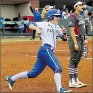  ?? Tulsa World/HUGH SCOTT ?? Tulsa’s Haley Meinen circles the bases after hitting a leadoff home run in the bottom of the seventh to beat Arkansas 5-4 and drop the Razorbacks to the losers bracket at the NCAA Regional at Norman, Okla., on Friday.