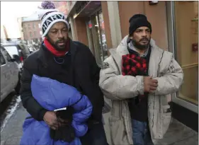  ??  ?? In this Wednesday photo, homeless men Sean Stuart (left) and Segundo Rivera walk on a street after spending the day at St. Francis House in Boston. CHRISTOPHE­R EVANS/THE BOSTON HERALD VIA AP
