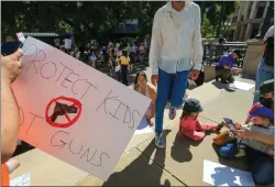  ?? RAY CHAVEZ — STAFF PHOTOGRAPH­ER ?? People make signs at Frank Ogawa Plaza in Oakland before a March for Our Lives rally in support of gun control on June 11. Congress is weighing a package of bills to limit gun access.