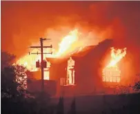  ?? JOSH EDELSON/AFP/GETTY IMAGES ?? The Signorello Estate winery burns in Napa. Most of the fatalities are in Sonoma County. Huge swaths of the Santa Rosa area were leveled.