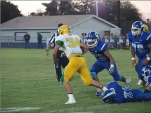  ?? KARINA LOPEZ PHOTO ?? Central Union High’s Andres Garcia (right) prepares to take down a Coachella Valley player during Friday’s game.