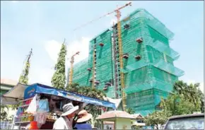  ??  ?? Three elevator repairmen were crushed to death on Saturday after a 16-storey-tall scaffoldin­g collapsed on top of them.