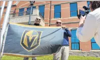  ?? COLIN MACLEAN/JOURNAL PIONEER ?? The City of Summerside raised two Vegas Golden Knight flags Monday to help show the community’s support for the team, which is coached by Summerside’s Gerard Gallant. Raising the flag at city hall was Robbie Rankin, left, event and corporate services...