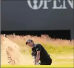  ?? JON SUPER/AP PHOTO ?? Kevin Kisner chips out of a bunker on the 18th hole during the first round of the British Open on Thursday in Carnoustie, Scotland. Kisner finished with a 5-under-par 66.